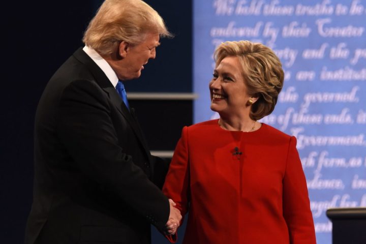 2016-09-27 01:04:14 Democratic nominee Hillary Clinton (R) shakes hands with Republican nominee Donald Trump during the first presidential debate at Hofstra University in Hempstead, New York on September 26, 2016. / AFP PHOTO / Timothy A. CLARY