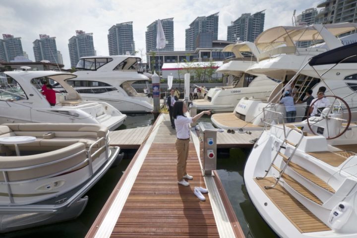 epa02663869 A visitor walks on as yachts from around the world are on show at the 'Hainan Rendezvous 2011' luxury lifestyle show aimed at China's new class of super rich in Sanya, Hainan, China, 01 April 2011. All kinds of luxury goods from Rolls Royces and Ferraris to 170 foot yachts as well as property agents from Monaco and French wine dealers were looking to attract China's millionaires and billionaires. Hainan Rendezvous 2011 runs until 04 April 2011. EPA/ADRIAN BRADSHAW
