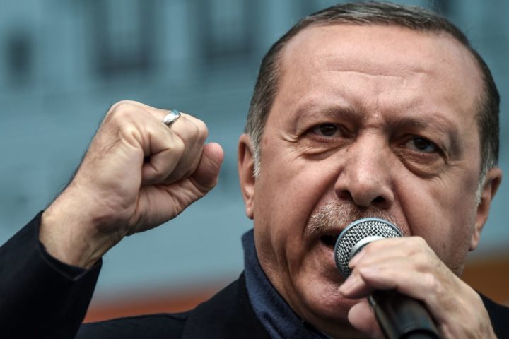 2017-03-26 13:08:39 Turkish President Recep Tayyip Erdogan gestures as he delivers a speech during a rally on March 26, 2017 in Istanbul. Turkish President Recep Tayyip Erdogan on March 26 lashed out again in the diplomatic row with the European Union saying it would be "easier" if the EU just rejected Turkey's bid to join the bloc. / AFP PHOTO / OZAN KOSE