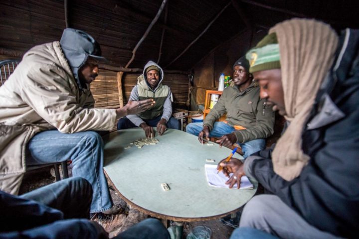 2015-12-24 17:14:55 epa05080291 Refugees playing dominoes the day before Christmas in the camp called 'The Jungle' in the port of Calais, France, 24 December 2015. Part of Calais migrant camp are Christians and celebrate Christmas. Currently the camp in Calais is housing around 1500 migrants who are looking to cross the English Channel to Britain. Among the migrants of the 'Jungle' are refugees and asylum seekers from Afghanistan, Darfur, Syria, Iraq and Eritrea. EPA/STEPHANIE LECOCQ