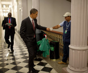 President Barack Obama fist-bumps custodian Lawrence Lipscomb in the Eisenhower Executive Office Building following the opening session of the White House Forum on Jobs and Economic Growth, Dec. 3, 2009. (Official White House Photo by Pete Souza) This official White House photograph is being made available only for publication by news organizations and/or for personal use printing by the subject(s) of the photograph. The photograph may not be manipulated in any way and may not be used in commercial or political materials, advertisements, emails, products, promotions that in any way suggests approval or endorsement of the President, the First Family, or the White House.